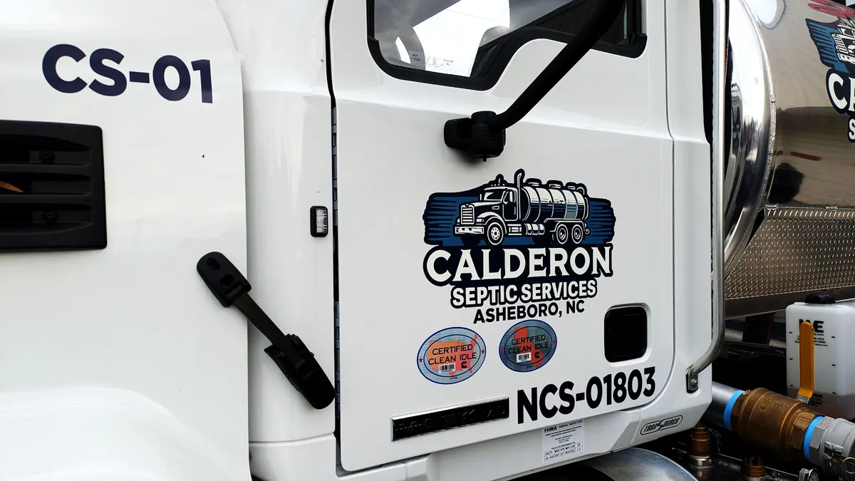 White service truck cab door lettered for Calderon Septic Services, Asheboro, NC, with a illustrated septic tanker truck graphic in navy and red above the company name.